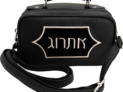 נרתיק מהודר לאתרוג מטקסטורה דמוית עור, בעל ידית נשיאה עליונה, רצועת כתף ארוכה ורקמה בולטת ועליה המילה אתרוג בחזית.